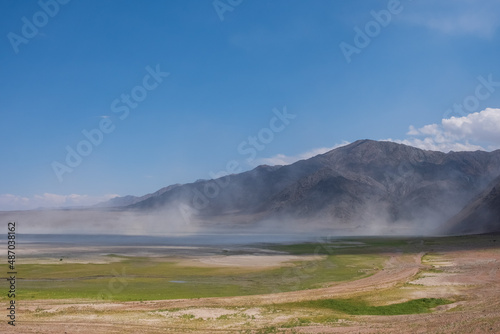 Dust storm on the bottom of dried Bartogay reservoir. Weather background. Nature abstract background.