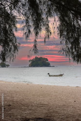 Long tail Boat on colourful sunset over a Beach in Phuket Thailand