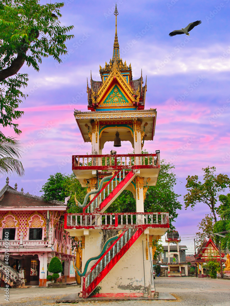 Beautiful Wat Buddhist temples in Phuket Thailand. Decorated in beautiful ornate colours of red and Gold and Blue. Lovely sunset