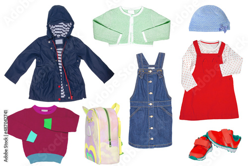 Collage set of little girl spring clothing isolated on a white background. The collection of a stylish blue down jacket, a sweater, a jeans skirt, sneaker,a bag and a dress with hood. Kids autumn and  © Olga
