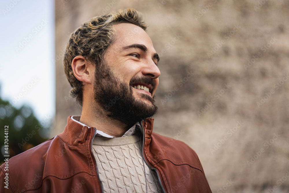 Cheerful young man smiling - Portrait of a 25-30 years old bearded young man - copy space Cheerful young man smiling - Portrait of a 25-30 years old bearded young man - copy space