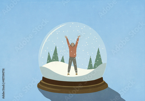 Woman with arms raised inside snow globe
 photo