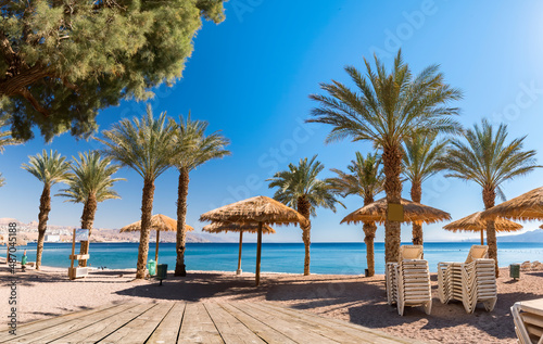 Morning on sunny central public beach in Eilat - famous tourist resort and recreational city in Israel