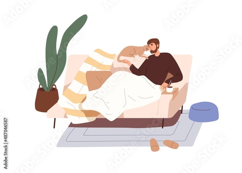 Man relaxing on sofa with cat. Person resting on couch with kitty at home. Ha...