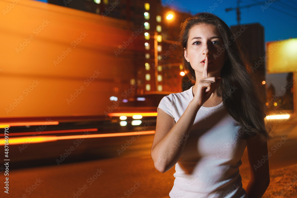 Girl on blurred background of night cit, freezelight, motion blur. Woman at road with busy traffic, copy space. Girl on blurred background of night cit, freezelight, motion blur. Woman at road with busy traffic, copy space.