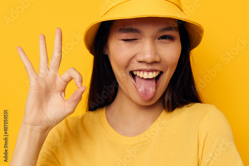 Portrait Asian beautiful young woman in a yellow t-shirt and hat posing emotions Lifestyle unaltered