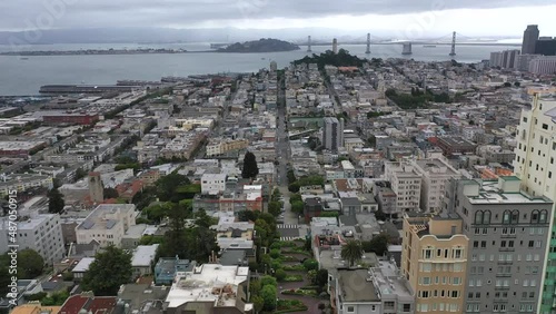 Lombard Street In San Francisco With San Francisco-Oakland Bay Bridge In USA. - aerial