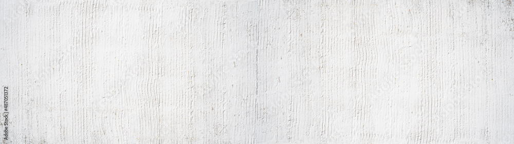 White rough filler plaster facade wall texture background.banner panorama, with vertical line corrugation White rough filler plaster facade wall texture background.banner panorama, with vertical line corrugation