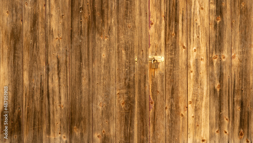 Old brown rustic dark grunge wooden timber wall texture with padlock - wood background banner.. photo