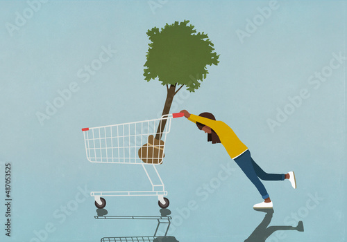 Girl pushing heavy shopping cart with tree sapling
 photo