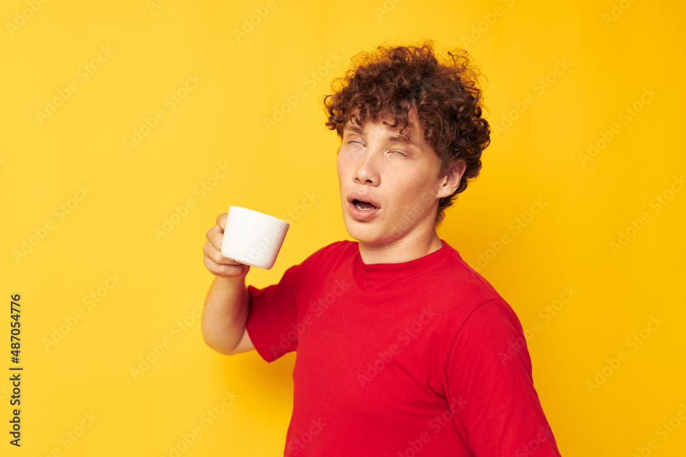 guy with red curly hair posing with a white mug and in the hands of a drink isolated background unaltered guy with red curly hair posing with a white mug and in the hands of a drink isolated background unaltered