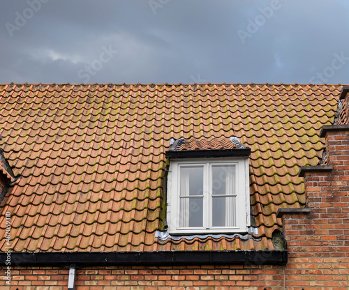 Tiled roof of an old house in Bruges, Belgium
