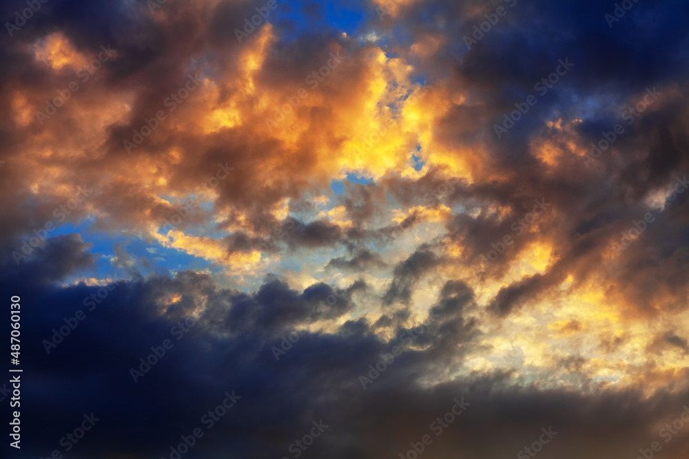 Colorful and dark clouds on sunset sky . Fantastic heaven in the evening