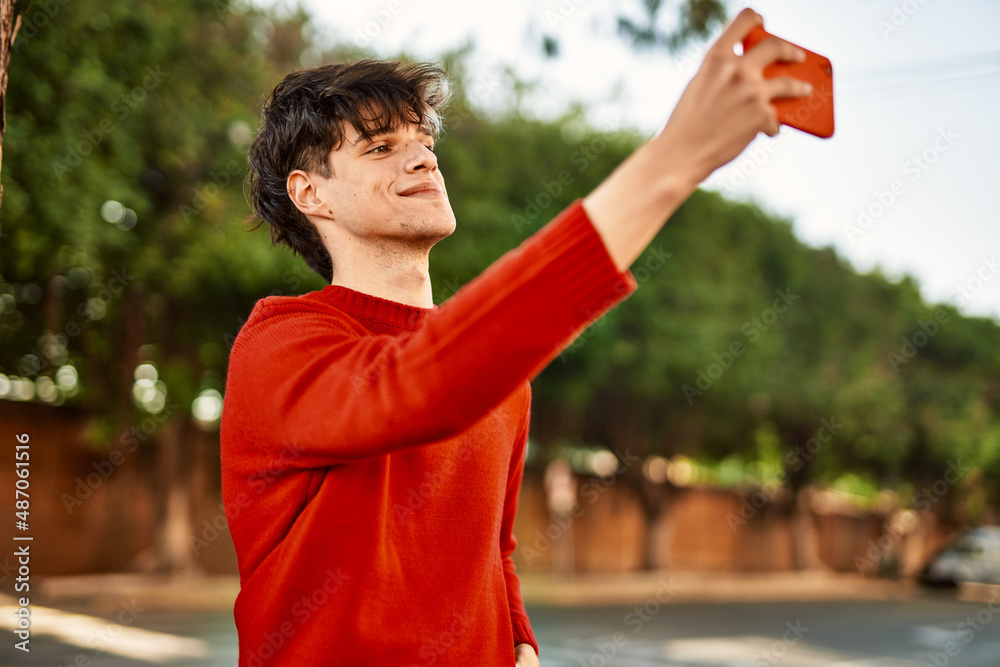 Young hispanic man smiling happy making selfie by the smartphone at the city.