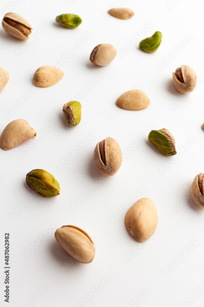 Close up of roasted pistachios isolated on white background. Close up of roasted pistachios isolated on white background.