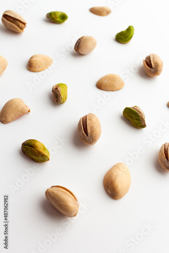 Close up of roasted pistachios isolated on white background.