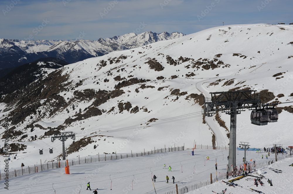Skiing resort in Grandvalira in Pyrenees mountain range in Andorra with snow on a sunny winter day