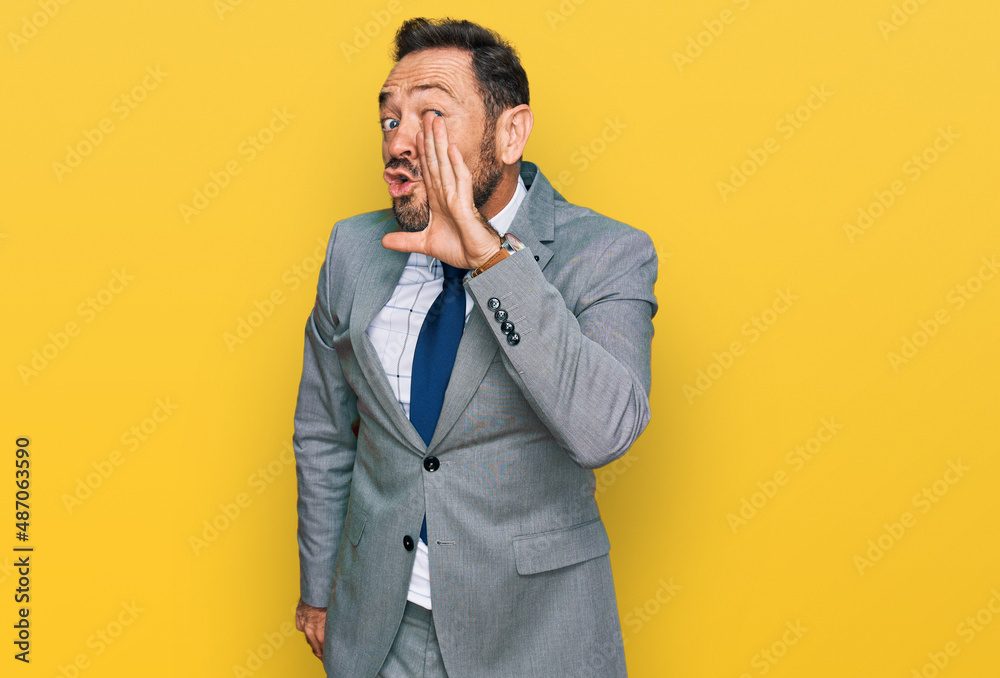 Middle age man wearing business clothes hand on mouth telling secret rumor, whispering malicious talk conversation - obrazy, fototapety, plakaty 