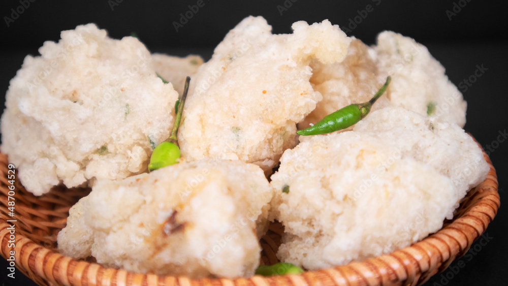 close up a bowl of fried tapioka flour in a black background close up a bowl of fried tapioka flour in a black background