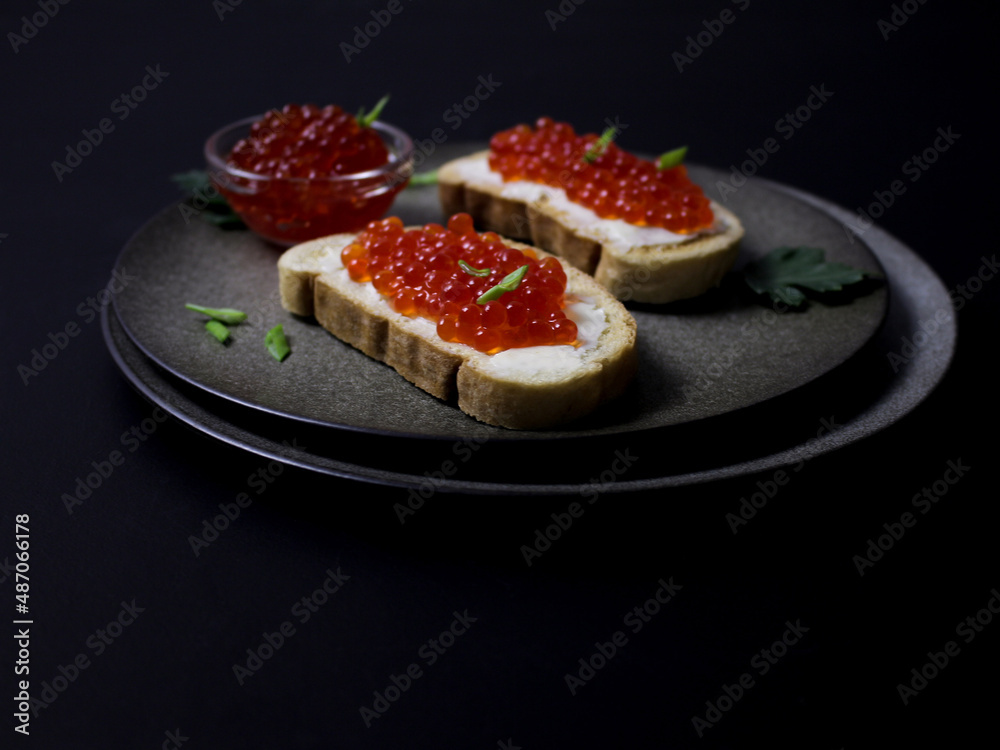 sandwiches with red caviar on a black background sandwiches with red caviar on a black background
