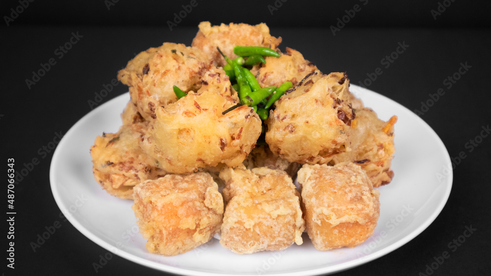 variation of indonesian fritters in a black background