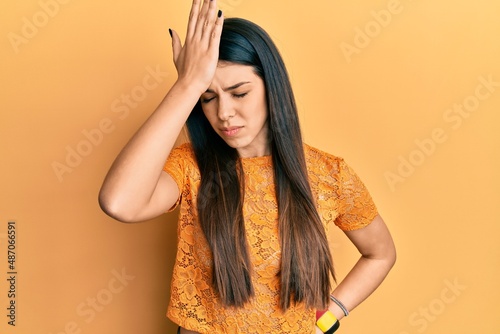 Young hispanic woman wearing casual clothes surprised with hand on head for mistake, remember error. forgot, bad memory concept.