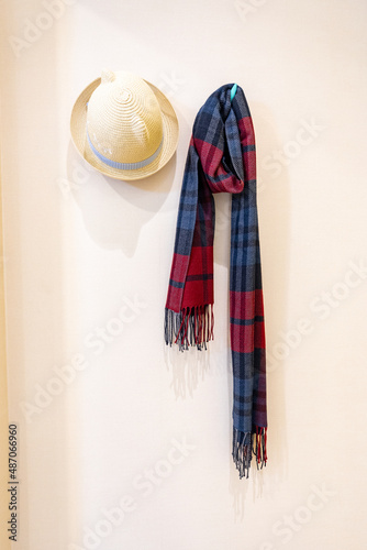 Scarves and hats hanging on the wall. photo