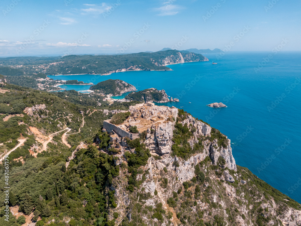 Aerial drone view of famous iconic medieval fortified castle of Aggelokastro with amazing views to Paleokastritsa bay, Corfu Greece