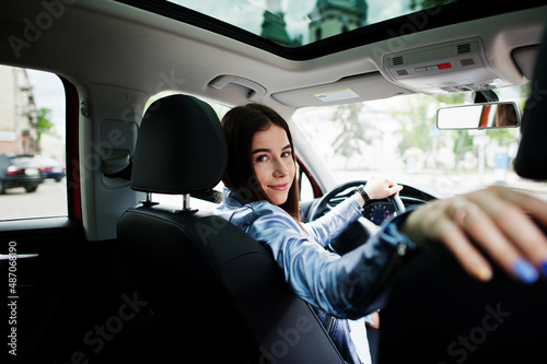 Gorgeous woman sitting inside car interior.