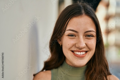 Young caucasian girl smiling happy standing at the city.