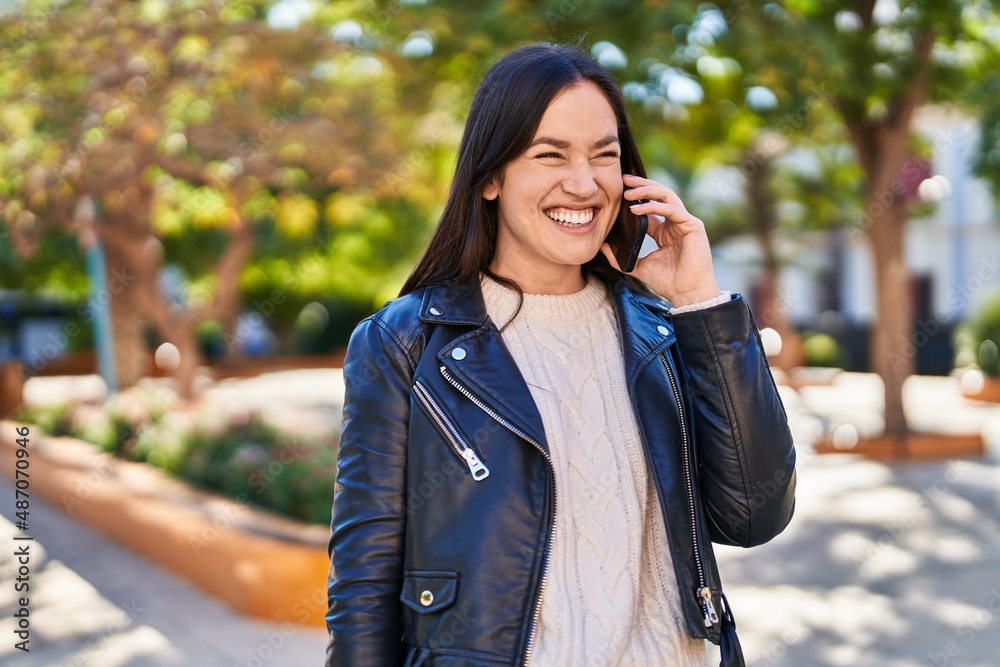 Young woman smiling confident talking on the smartphone at park Young woman smiling confident talking on the smartphone at park