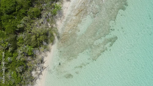 AERIAL - Boat on clear turquoise waters, Cayo Icacos, Puerto Rico, top down reverse photo