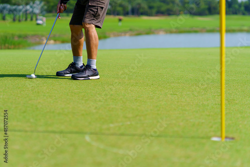 Golfer preparing for a putt Golf ball on the green during golfcourse