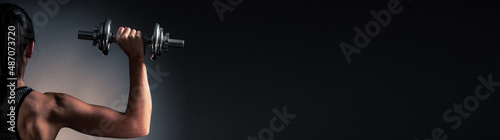 Beautiful young woman workout with dumbbell over gray background in fitness gym club