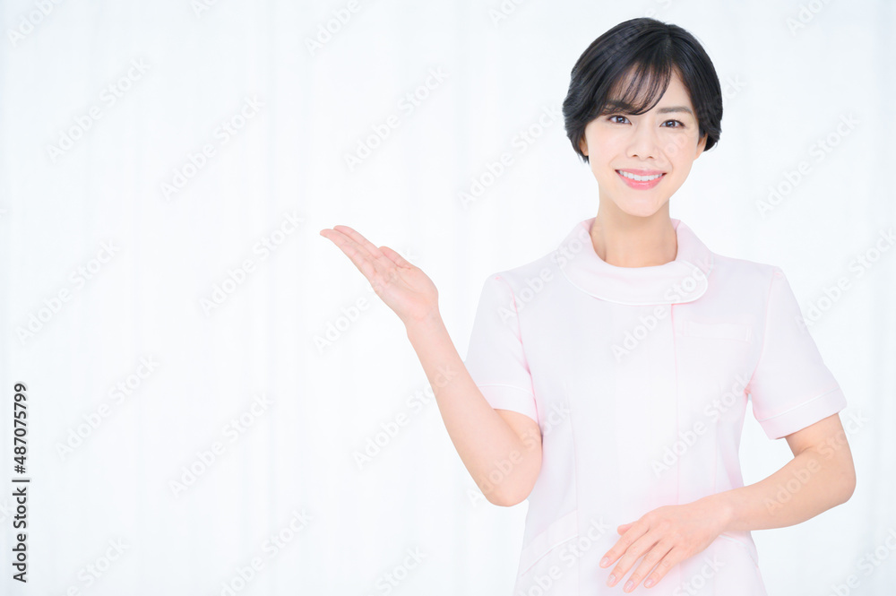 Portrait of a woman who recommends easy to use for beauty nurse or nurse image. Copy space available. Pink. Portrait of a woman who recommends easy to use for beauty nurse or nurse image. Copy space available. Pink.
