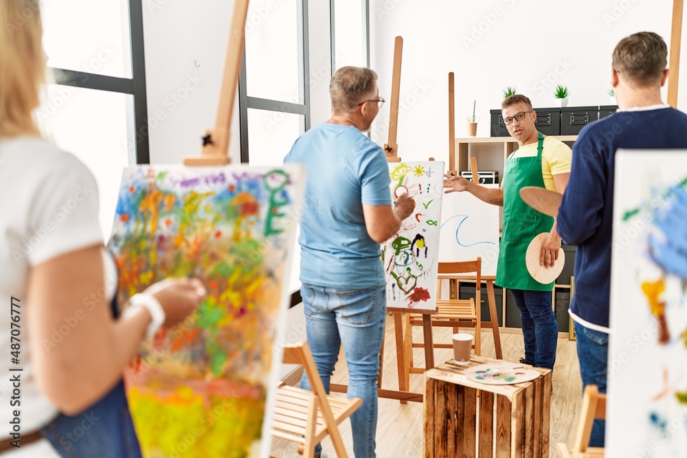 Group of middle age paint students having art class at drawing studio. Group of middle age paint students having art class at drawing studio.