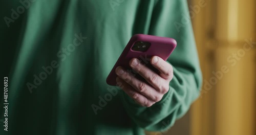 man's hand takes out a phone and types, then puts it away