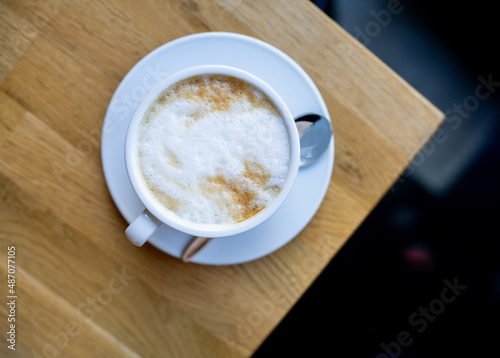 cup of cappuccino on wooden table