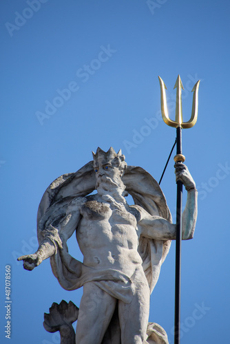 Statue of Poseidon in Ghent with blue background photo