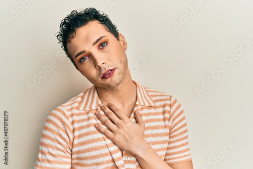 Handsome man wearing make up wearing casual shirt with angry face, negative sign showing dislike with thumbs down, rejection concept © Krakenimages.com