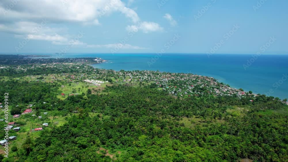 Aerial view towards the Pantufo town in sunny Sao Tome - approaching, drone shot