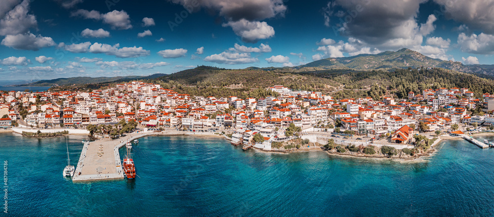 Wide aerial panoramic view of a resort sea town Neos Marmaras in Halkidiki, Sithonia. Travel destinations and real estate in Greece