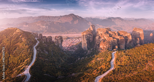 Inspirational aerial view of iconic and majestic Meteora monastery travel destination in Greece. Discover new tourist experience. Scenic roads leading to attractions