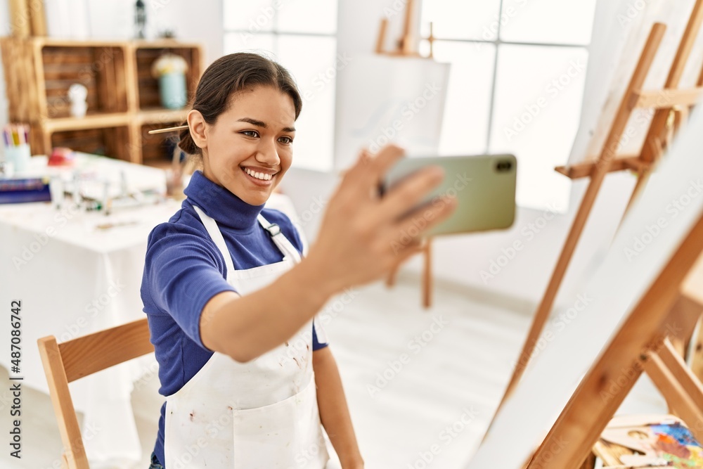 Young latin woman smiling confident make selfie by the smartphone at art studio Young latin woman smiling confident make selfie by the smartphone at art studio
