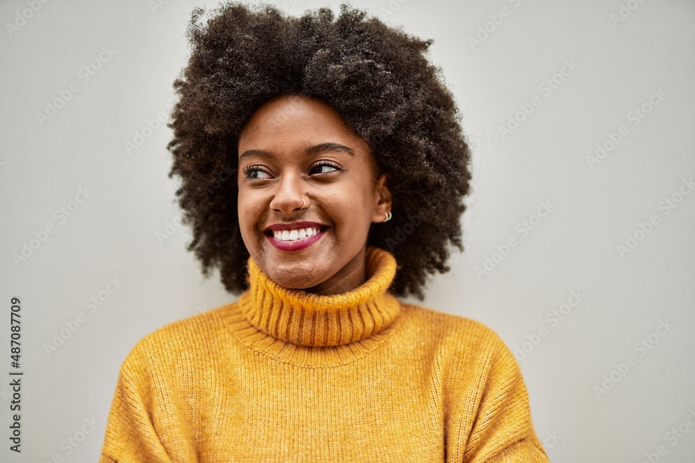 Young african american girl smiling happy standing at the city.