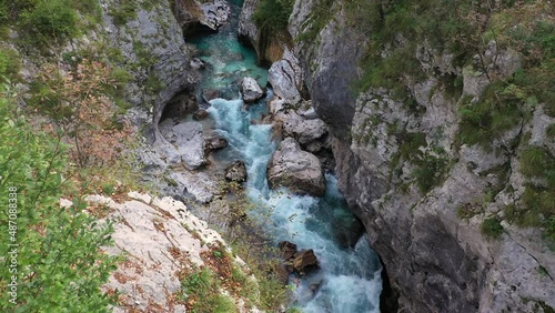 Aerial View Above The Surface Of A Mountain River Soca , stream flowing through rocky canyon. River stones with flowing water, clean water flowing in a mountain river