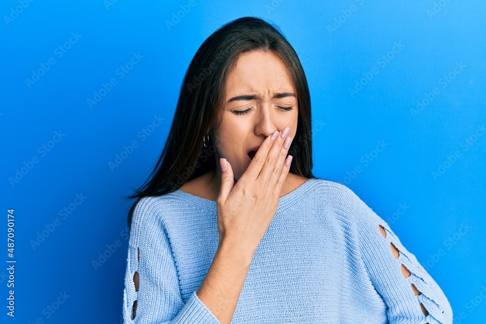 Young hispanic girl wearing casual clothes bored yawning tired covering mouth with hand. restless and sleepiness. Young hispanic girl wearing casual clothes bored yawning tired covering mouth with hand. restless and sleepiness.