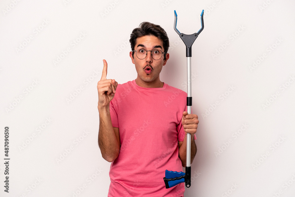 Young caucasian man holding a garbage collector isolated on white background having some great idea, concept of creativity. Young caucasian man holding a garbage collector isolated on white background having some great idea, concept of creativity.