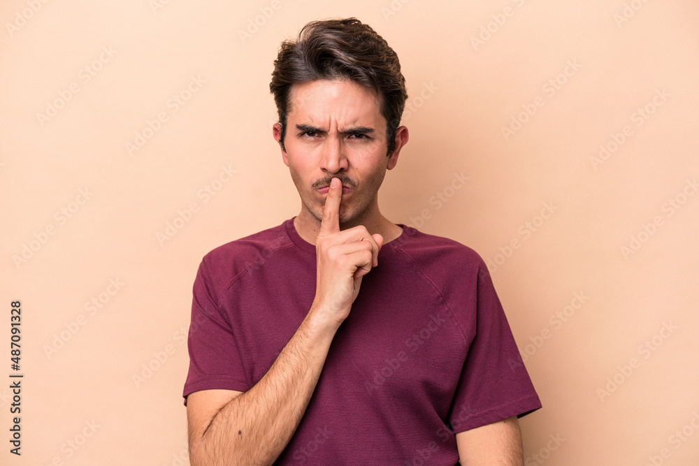 Young caucasian man isolated on beige background thinking and looking up, being reflective, contemplating, having a fantasy. Young caucasian man isolated on beige background thinking and looking up, being reflective, contemplating, having a fantasy.