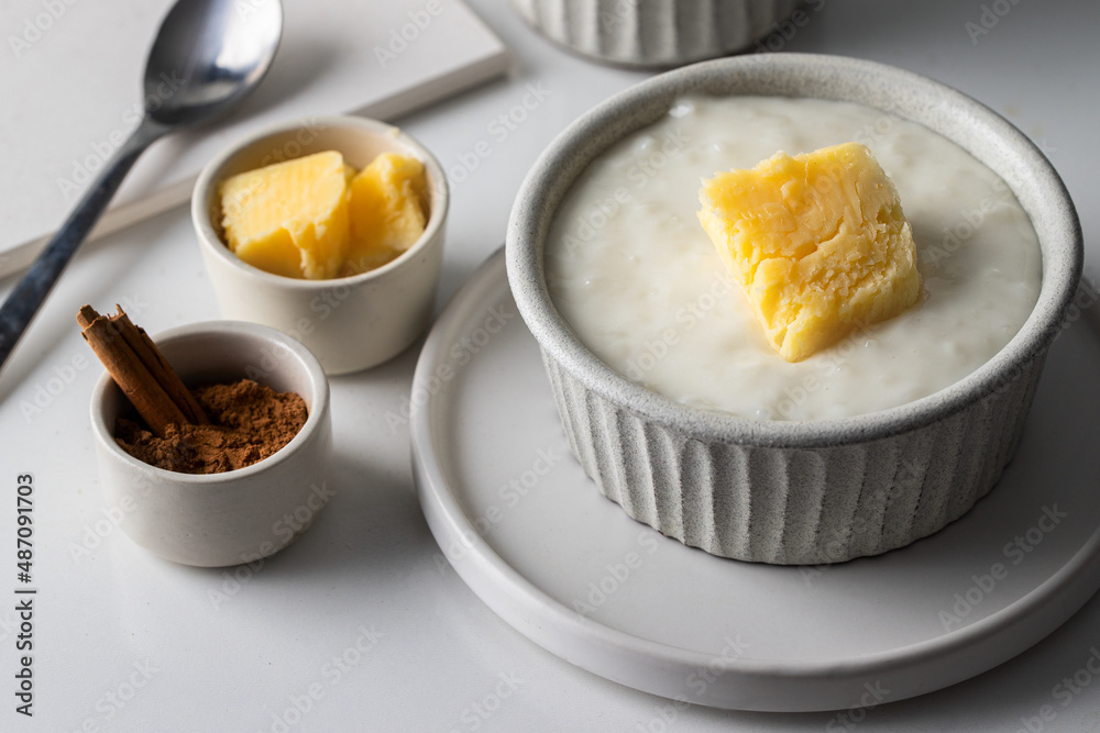 Risengrod food served with butter and cinnamon , This rice pudding or porridge, typical food in Scandinavian countries. Risengrod food served with butter and cinnamon , This rice pudding or porridge, typical food in Scandinavian countries.